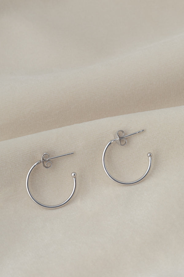 Silver hoop earrings Ava on textile