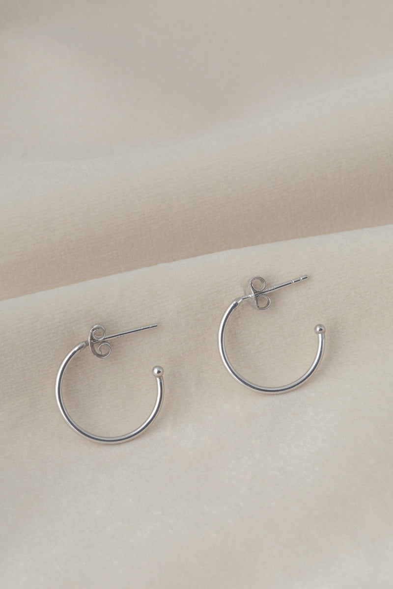 Silver hoop earrings Ava on textile